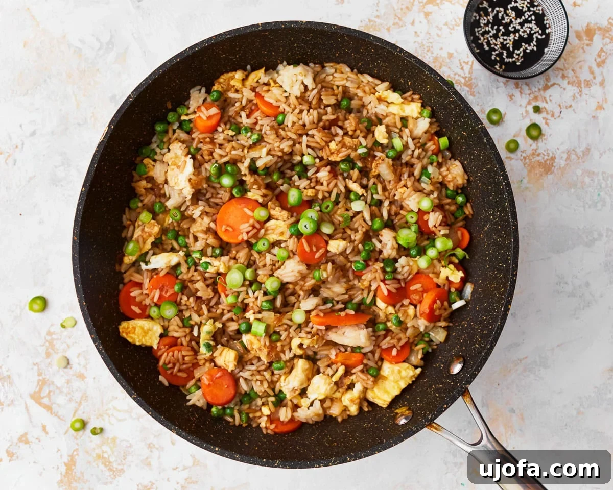 Your New Favorite Gluten-Free Fried Rice 11 Finished gluten-free fried rice, garnished with green onions, in a skillet.