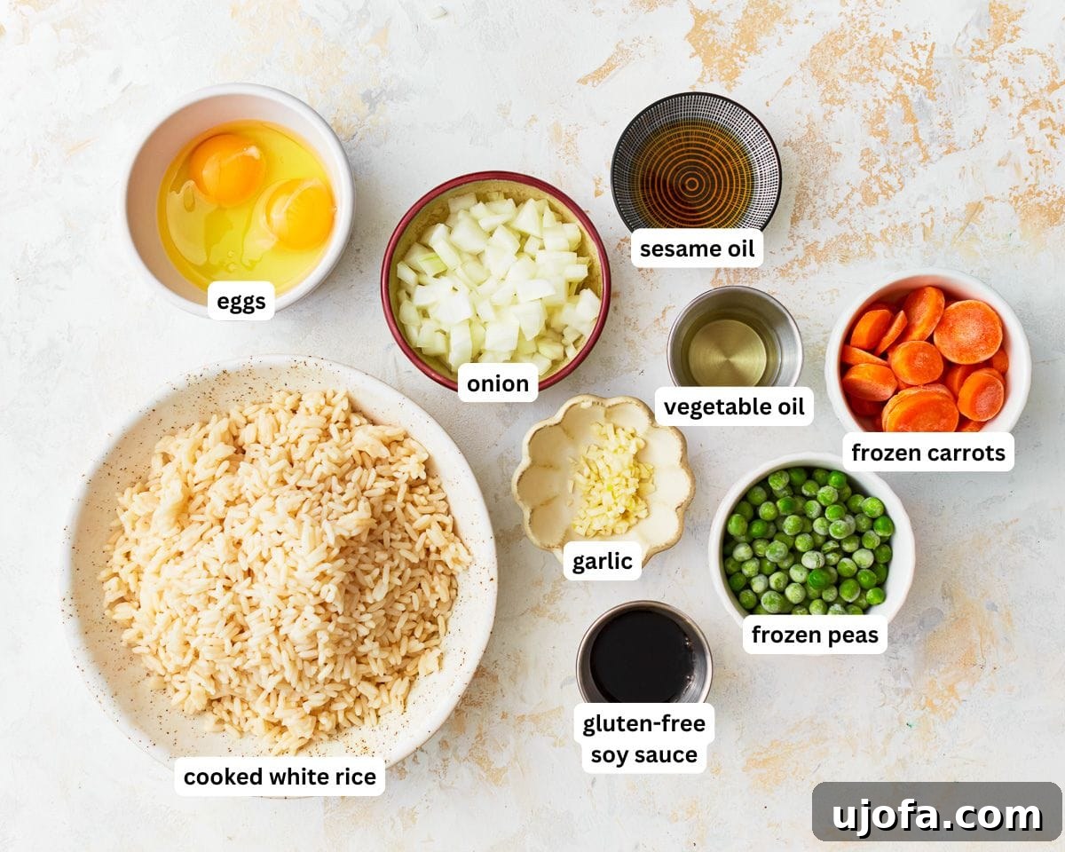 Your New Favorite Gluten-Free Fried Rice 3 A collection of fresh ingredients laid out for making gluten-free fried rice, including rice, eggs, vegetables, and sauces.
