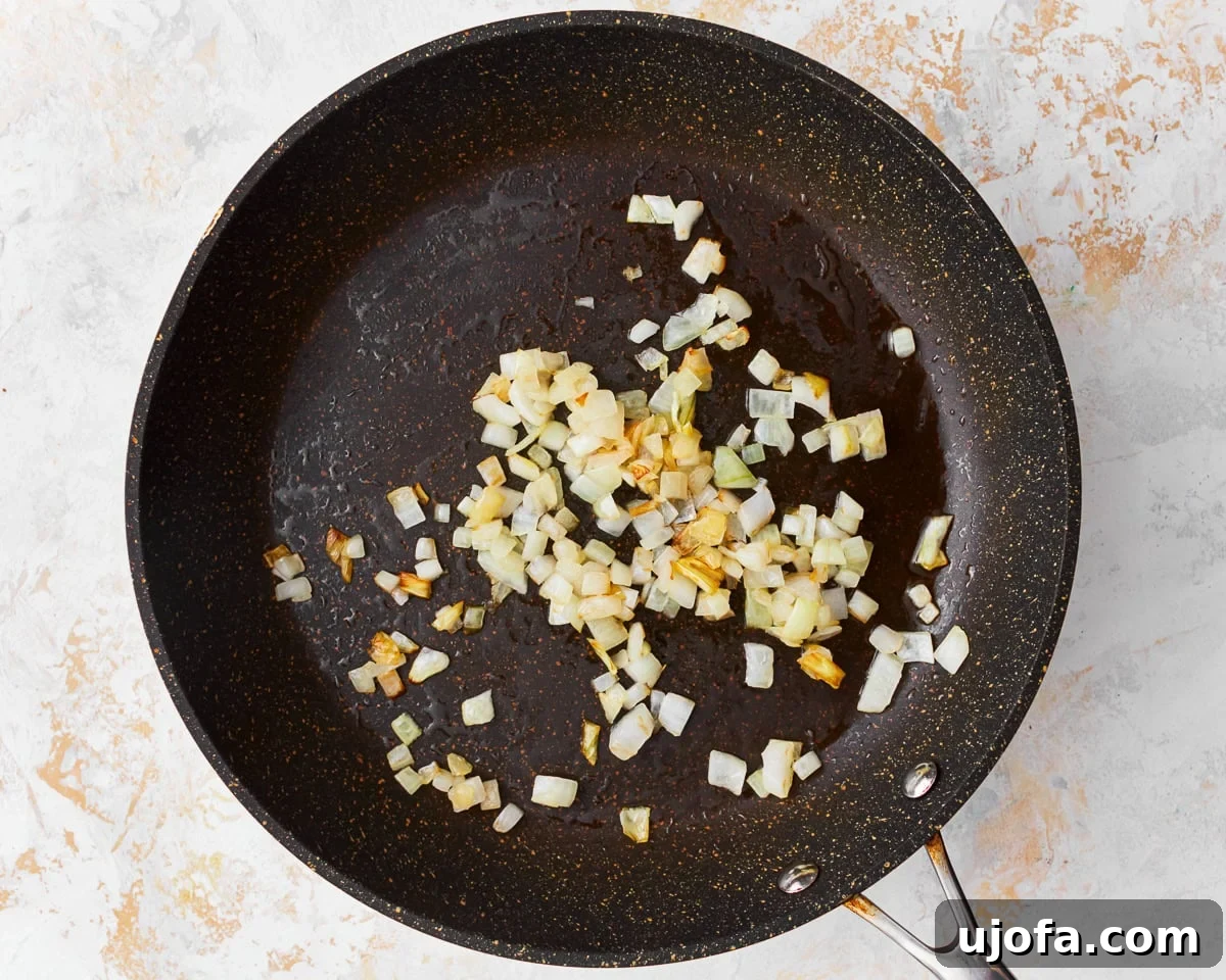 Your New Favorite Gluten-Free Fried Rice 6 Diced onions sautéing in a skillet, turning translucent.
