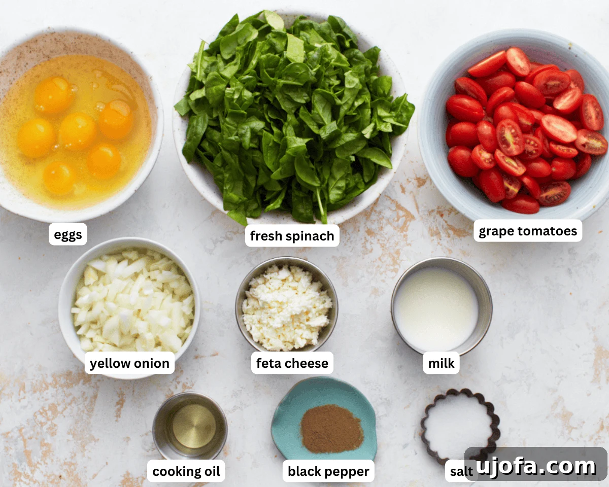 Savory Italian Egg Bake 5 All the fresh ingredients meticulously laid out for making a delicious gluten-free frittata egg casserole, including eggs, spinach, tomatoes, onion, and feta.