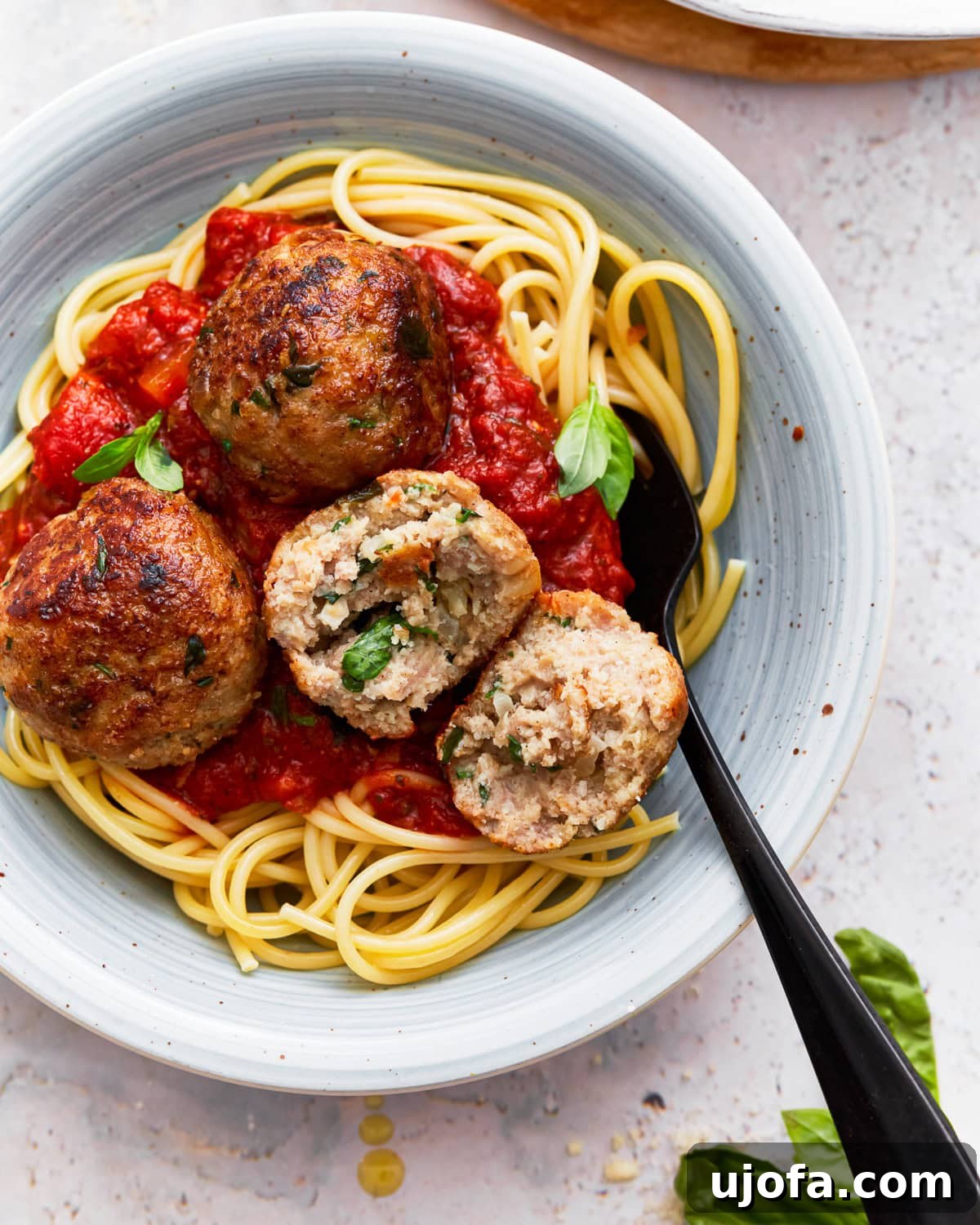 Delicious Gluten-Free Turkey Meatballs 2 Gluten free turkey meatballs on a plate with spaghetti and marinara sauce
