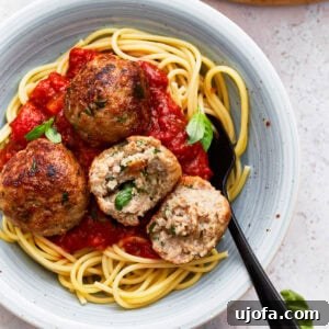 Gluten free turkey meatballs on a plate with spaghetti and marinara sauce