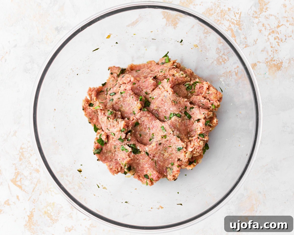 Delicious Gluten-Free Turkey Meatballs 8 The meat mixture for gluten-free turkey meatballs in a glass bowl.