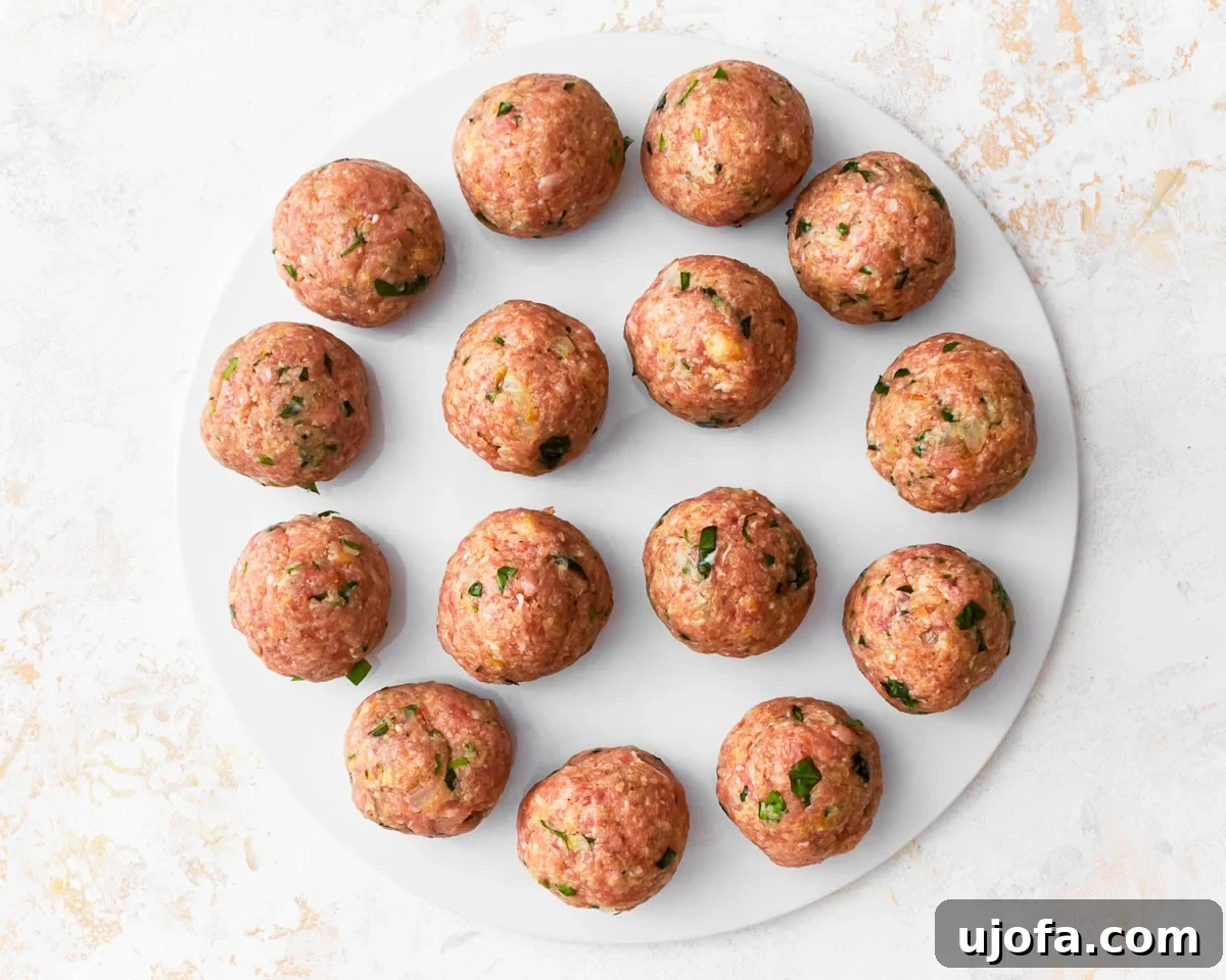 Delicious Gluten-Free Turkey Meatballs 9 Formed gluten-free meatballs on a white chopping board