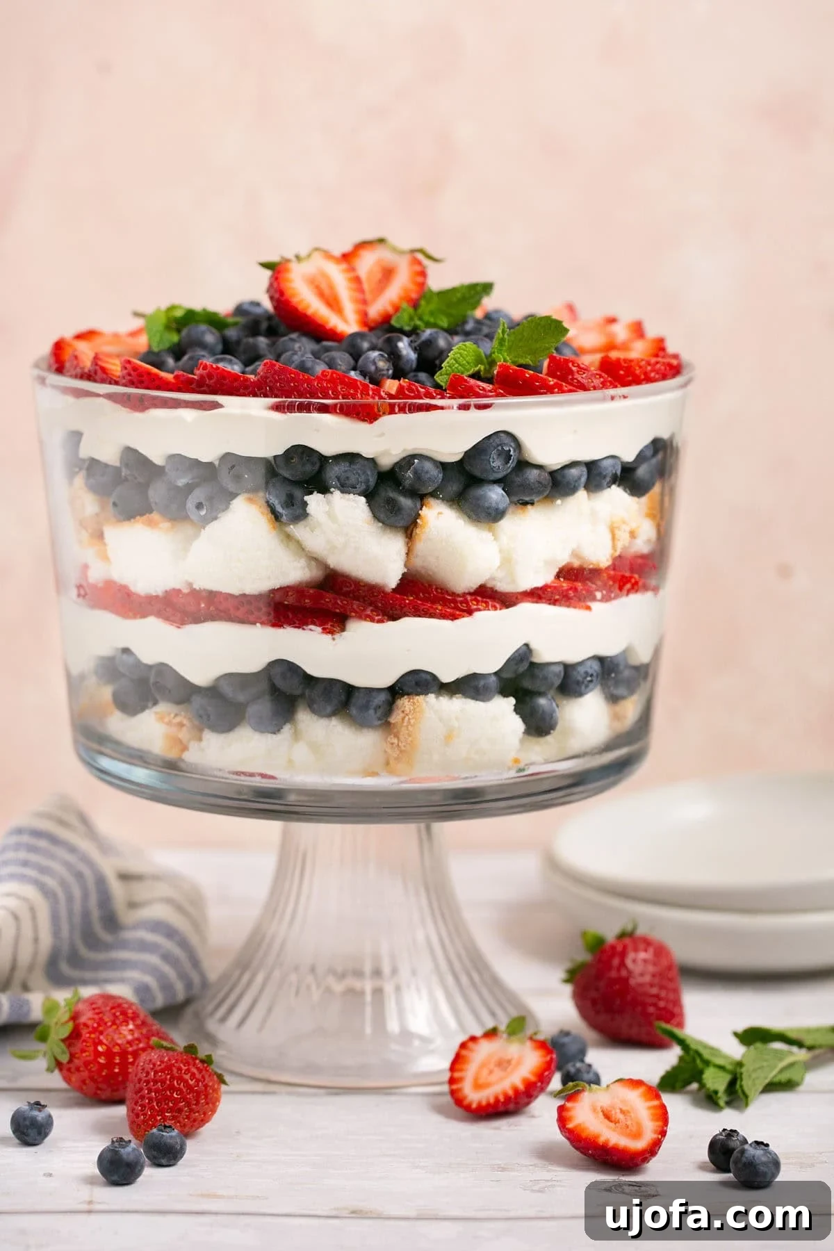 A large, perfectly baked, light, and airy gluten-free angel food cake, presented in a classic tube pan