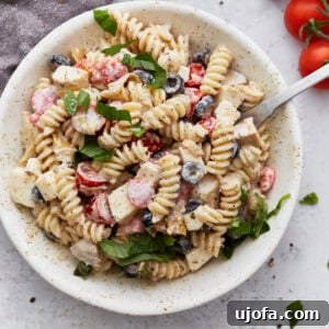 Creamy Italian Pasta Salad with rotini pasta, cherry tomatoes, black olives, and mozzarella cubes.