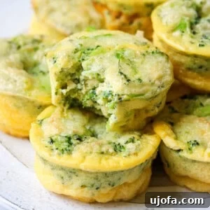 Keto Cheesy Broccoli Egg Muffins 8 broccoli cheddar keto egg bites stacked on a plate with a bite taken out