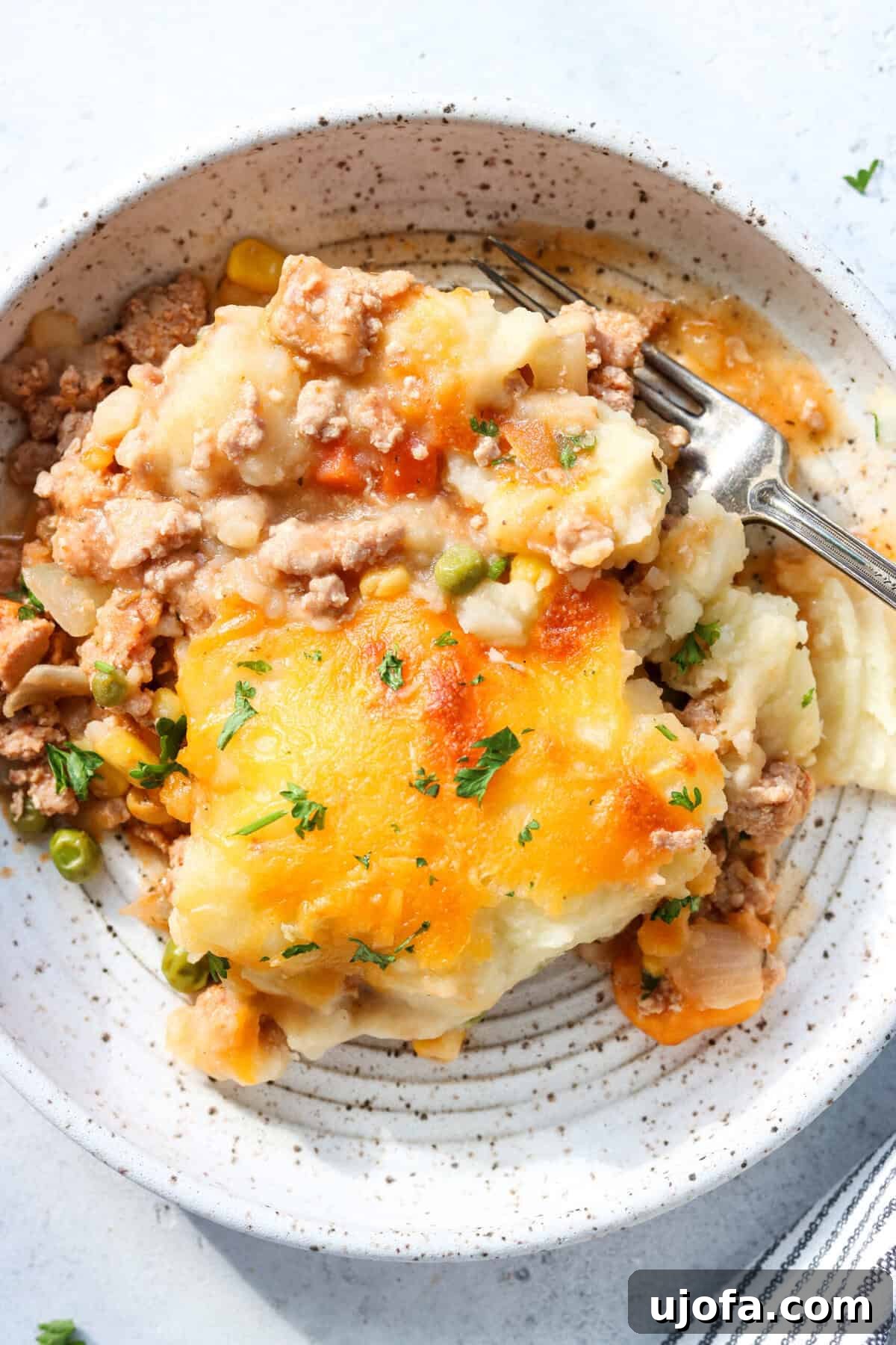 Savory Turkey Shepherd's Bake 7 ground turkey shepherd's pie in a bowl with a fork