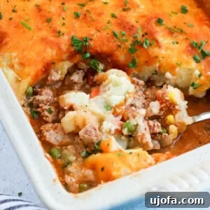 ground turkey shepherd's pie in a casserole dish with a scoop being taken out