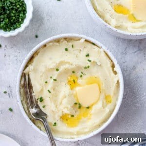 gluten free mashed potatoes in 2 bowls with chives and butter on the side