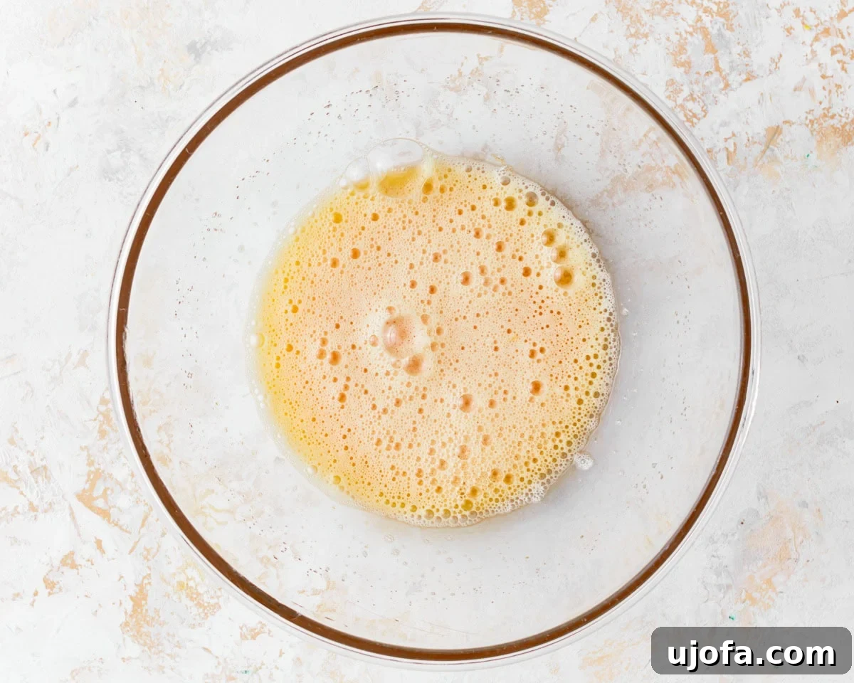 Tender Almond Flour Cake 7 Beaten eggs and sugar in a glass mixing bowl, light and fluffy.