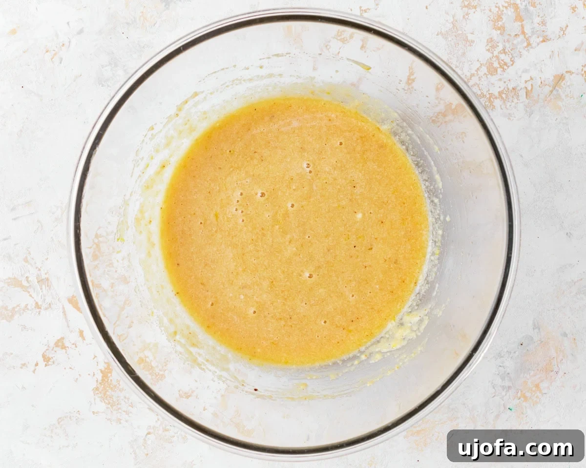 Tender Almond Flour Cake 8 Almond flour cake batter in a glass mixing bowl, showing its thick consistency.