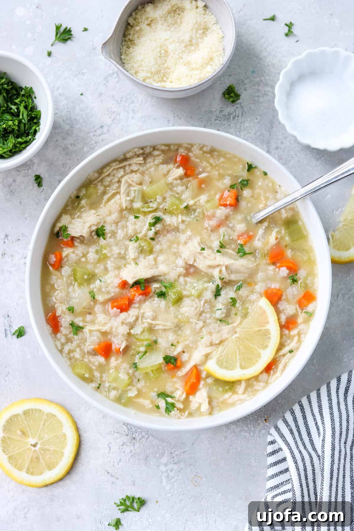 gluten free chicken pastina soup in a bowl topped with parsley