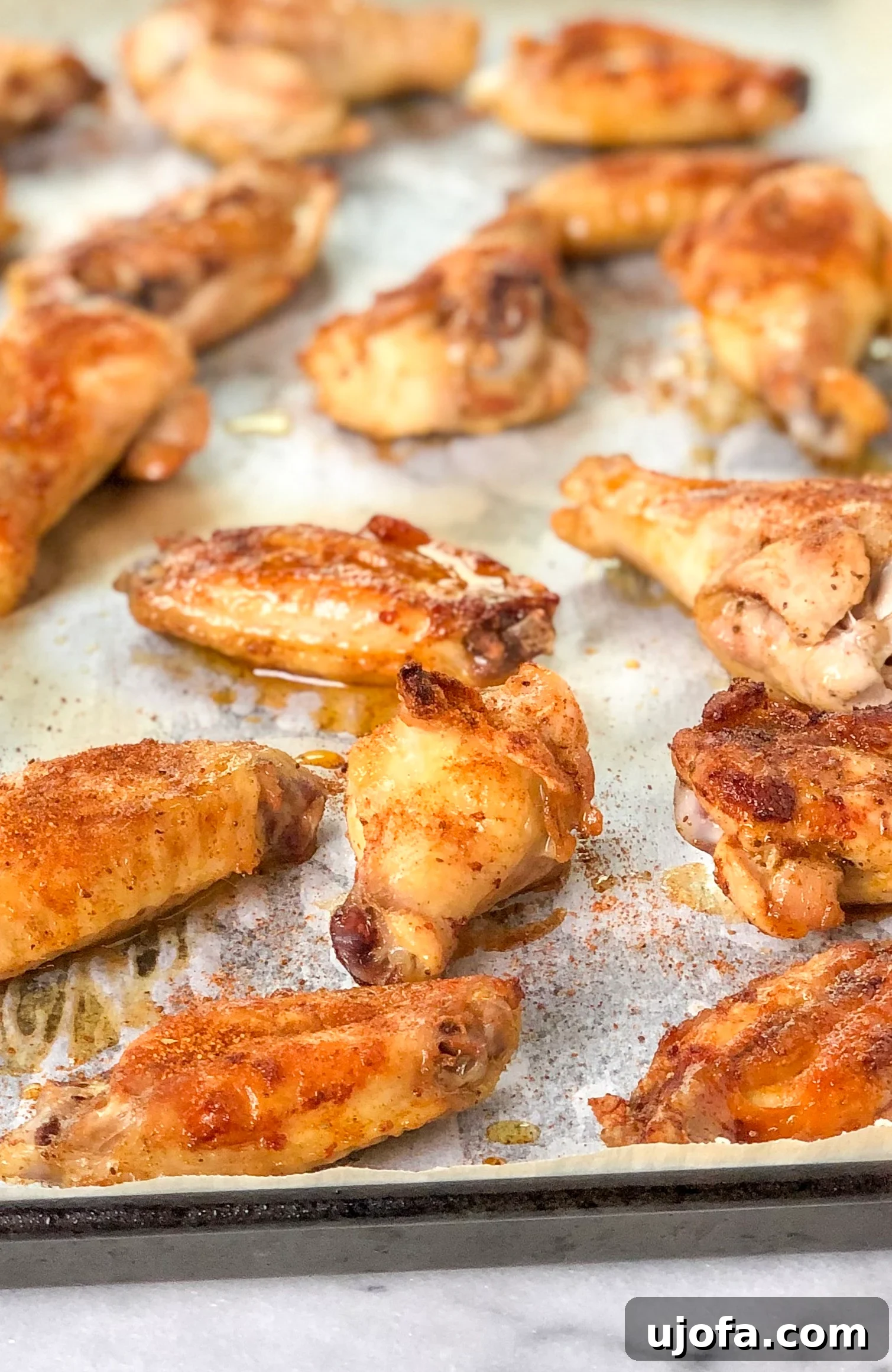 Crispy Paleo Old Bay wings on a baking sheet, ready to serve