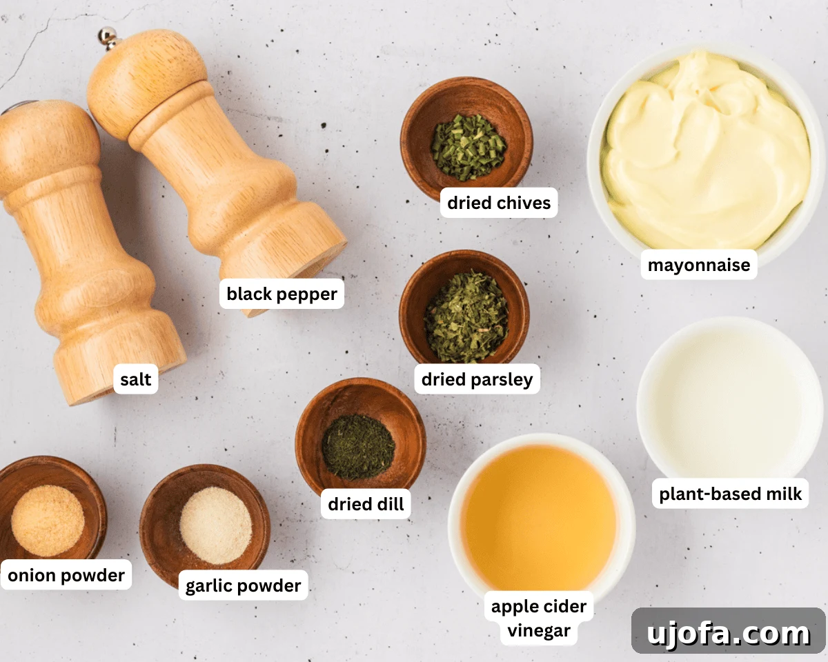 Luscious Plant-Based Ranch 4 Dairy-free ranch dressing ingredients laid out on a white surface, including mayonnaise, plant-based milk, apple cider vinegar, and various dried herbs and spices.