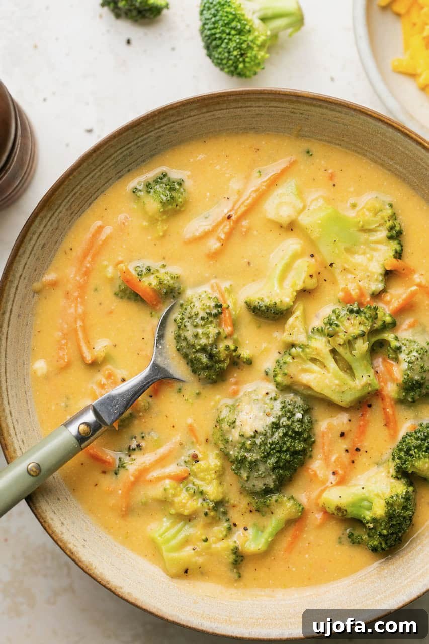 Creamy Instant Pot Broccoli Cheddar Soup 7 Broccoli cheddar soup in a bowl with a spoon, ready to be enjoyed