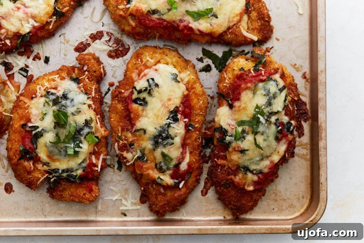 Irresistible Gluten-Free Chicken Parm 15 A close-up shot of the perfectly baked gluten-free chicken parmesan, highlighting the crispy breading, melted cheese, and aromatic fresh basil.