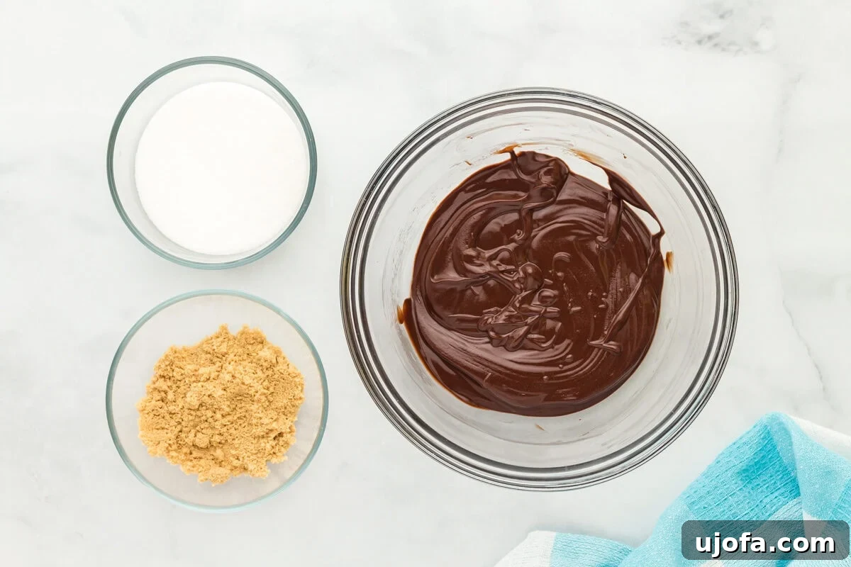 Fudgy Flourless Delights 6 Melted chocolate in a glass mixing bowl.
