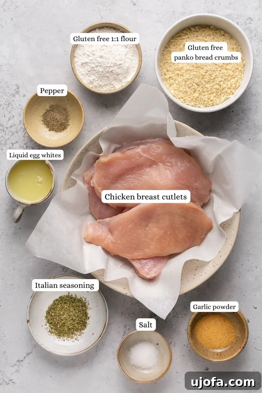 Ingredients for air fryer chicken cutlets arranged in nesting bowls: chicken, gluten-free panko, flour, egg whites, and seasonings.