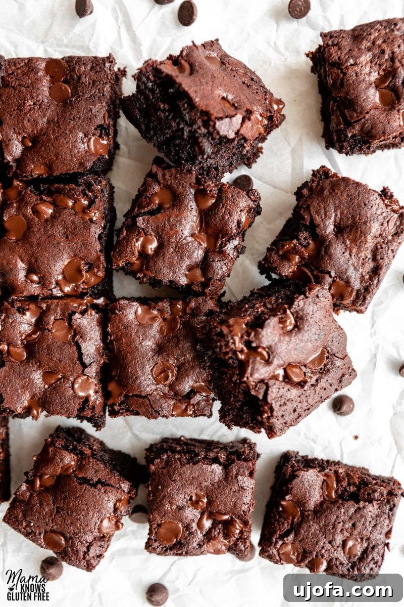 Cut up square of Almond Flour Brownies on parchment paper, showcasing their fudgy texture.