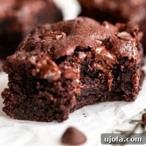A cut up square of Almond Flour Brownies, showcasing the dense, fudgy interior.