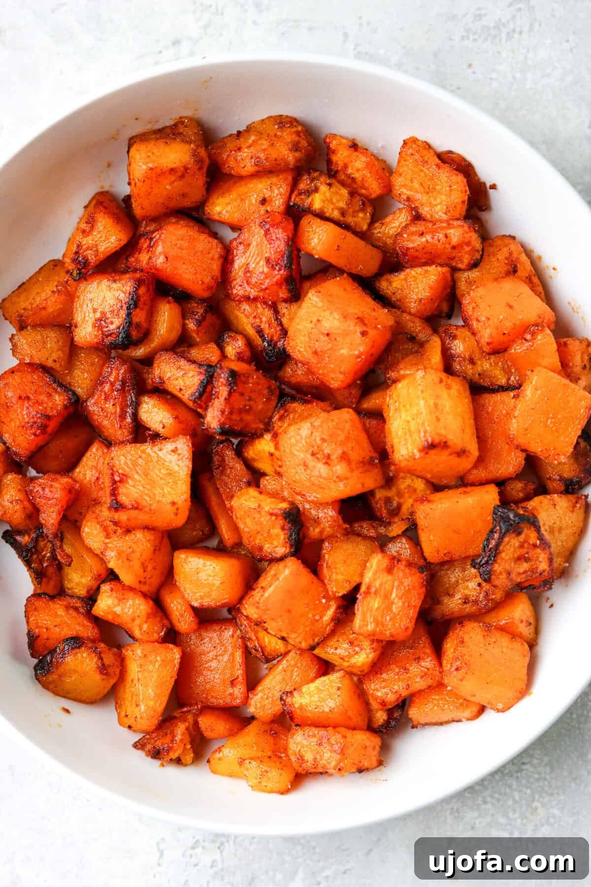 Effortless Air Fryer & Roasted Butternut Squash 2 Crispy Air Fryer Butternut Squash in a white bowl, ready to serve