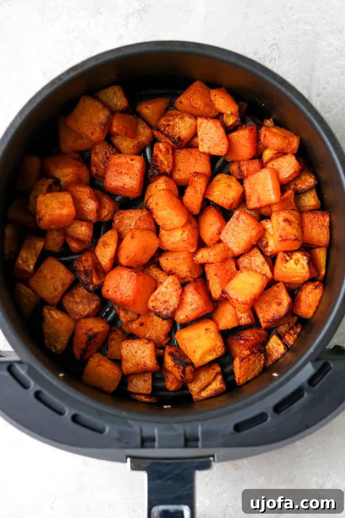 Effortless Air Fryer & Roasted Butternut Squash 6 Cooked, golden-brown butternut squash in an air fryer basket