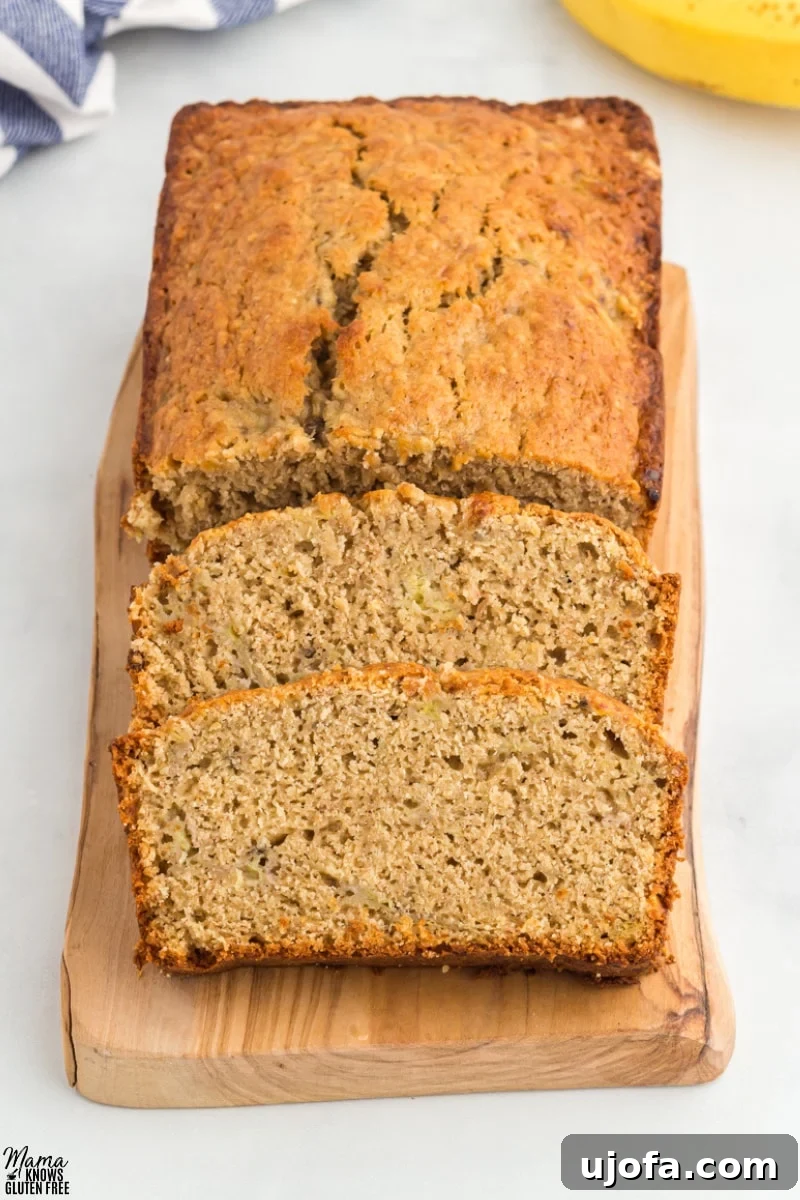 Oat Flour Banana Bread Recipe sliced on wooden board.