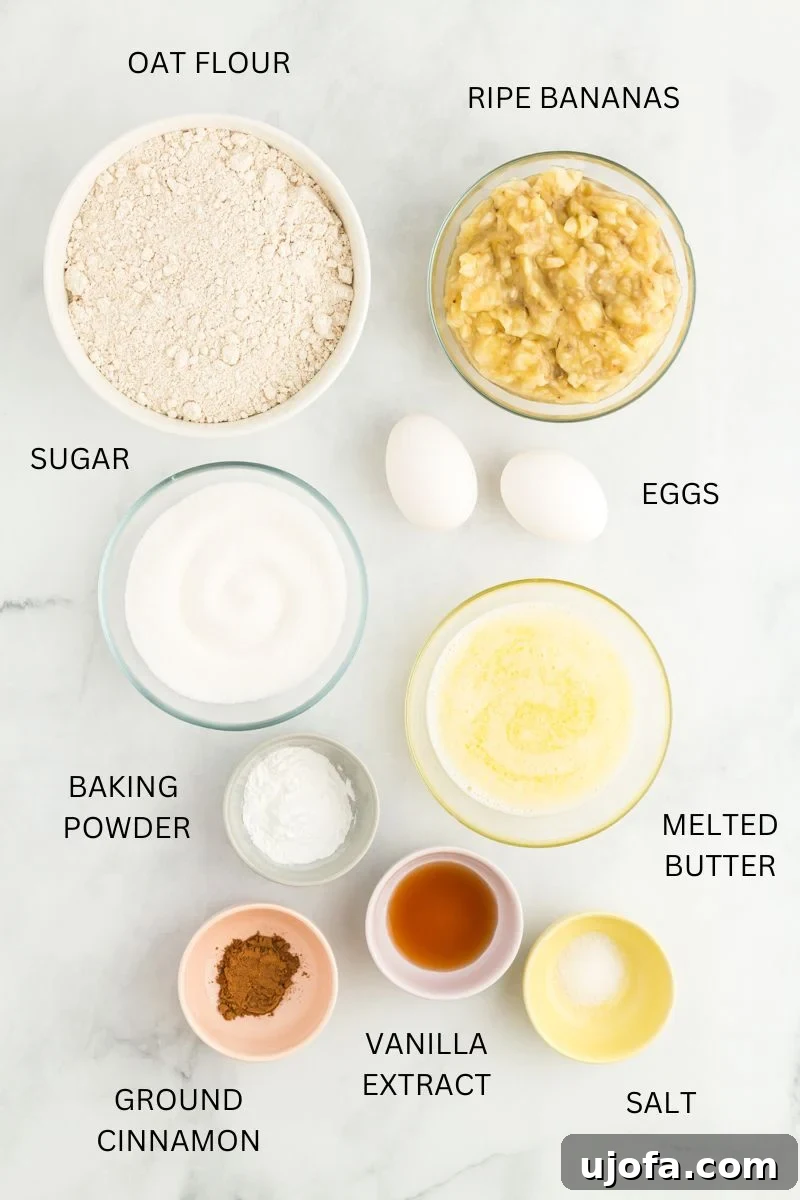 Oat Flour Banana Bread Recipe ingredients in bowls on white surface.