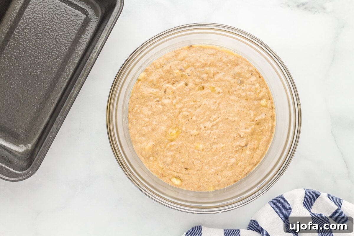 oat flour banana bread batter in a glass mixing bowl.