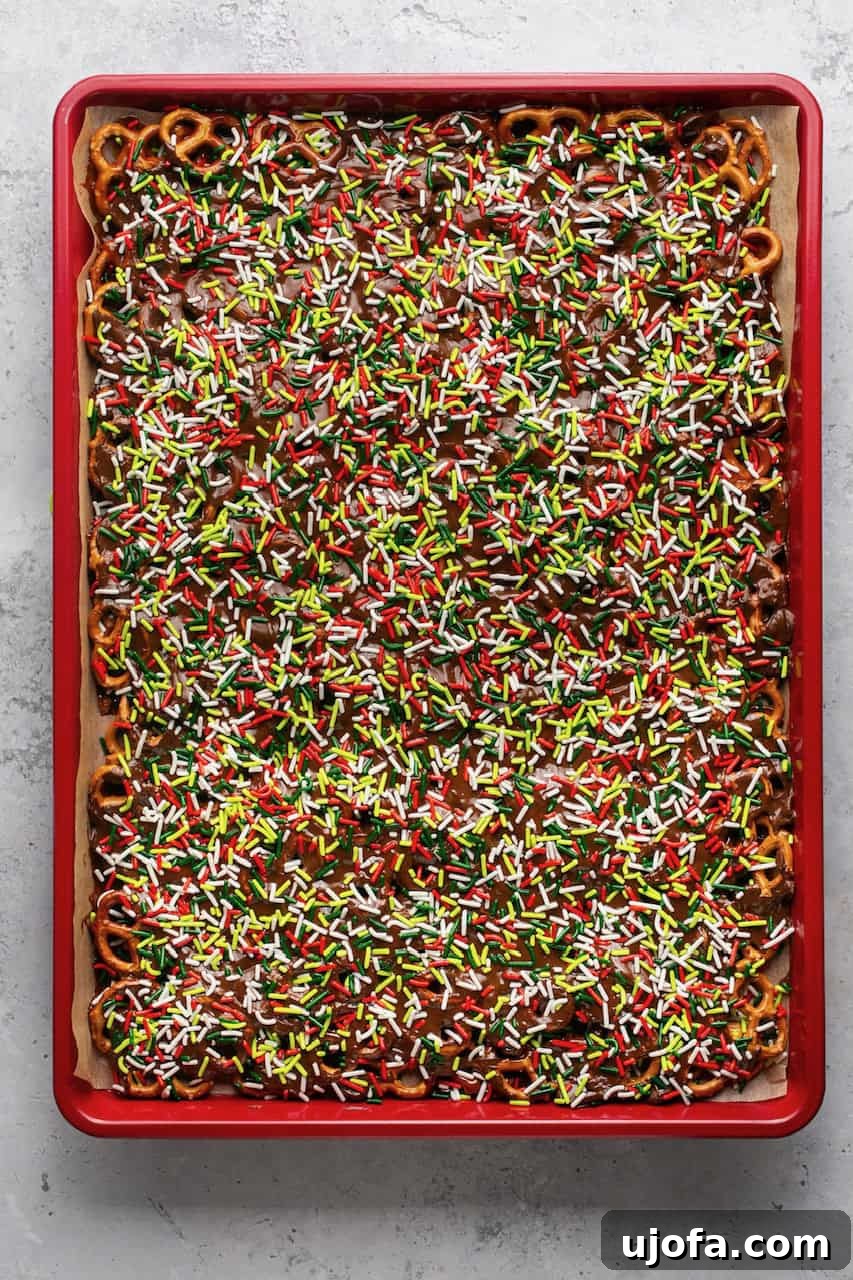 Finished pan of caramel and chocolate covered pretzels with sprinkles, ready for freezing