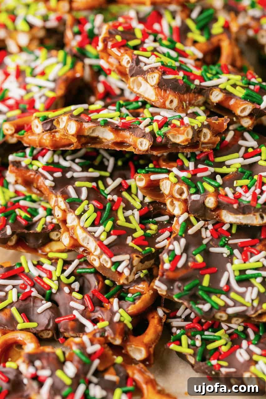 Large batch of Pretzel Christmas Crack spread out on parchment paper, ready to be broken into pieces
