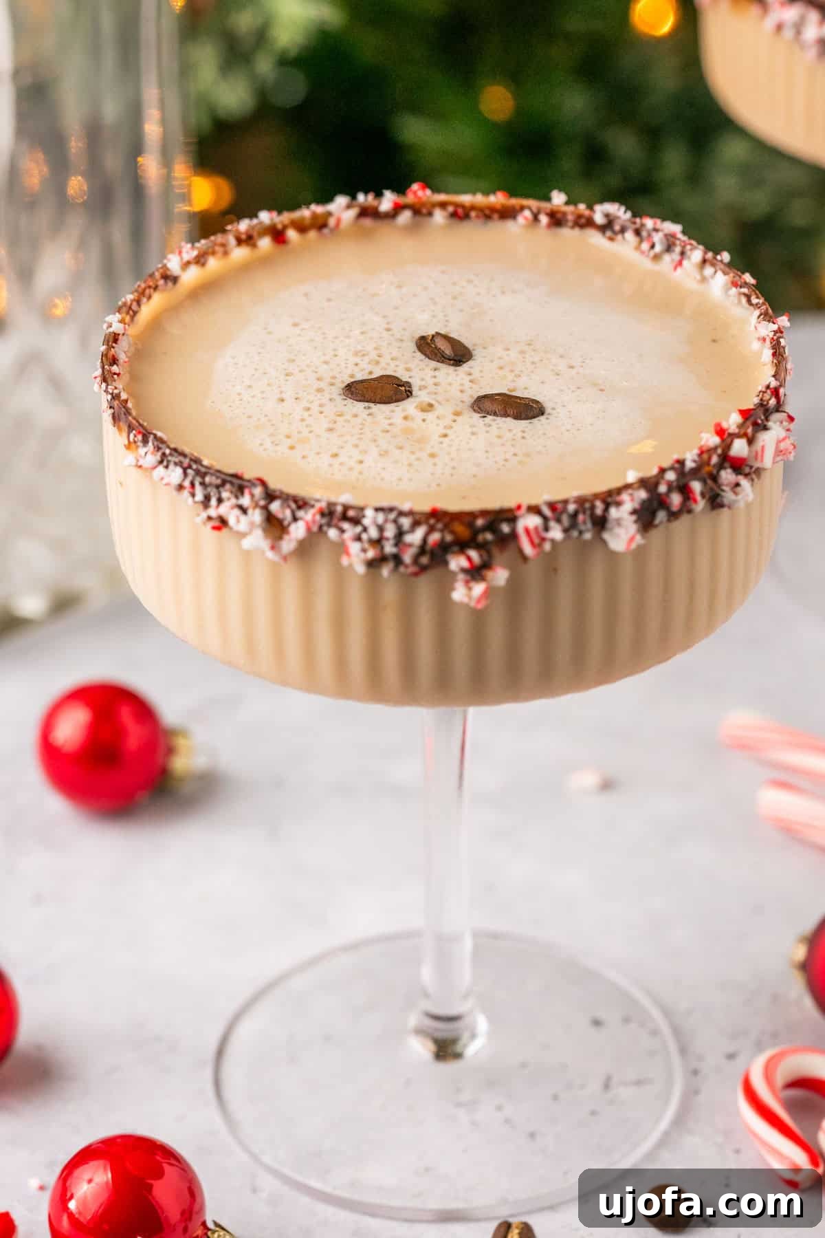 a closeup of an espresso martini with 3 coffee beans