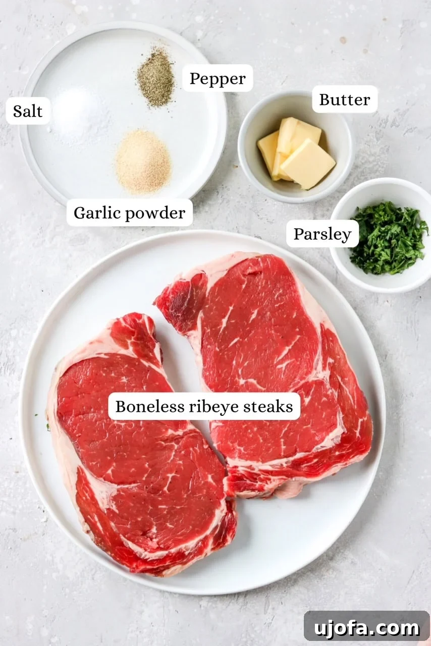 Ingredients meticulously laid out for preparing air fryer ribeye steaks, showcasing simplicity and quality.