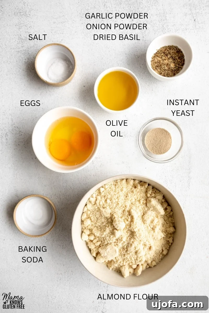 Crispy Gluten-Free Almond Flour Pizza Crust 3 Various ingredients for Gluten-Free Almond Flour Pizza Crust laid out in bowls, cups, and measuring spoons, including almond flour, eggs, olive oil, and spices.