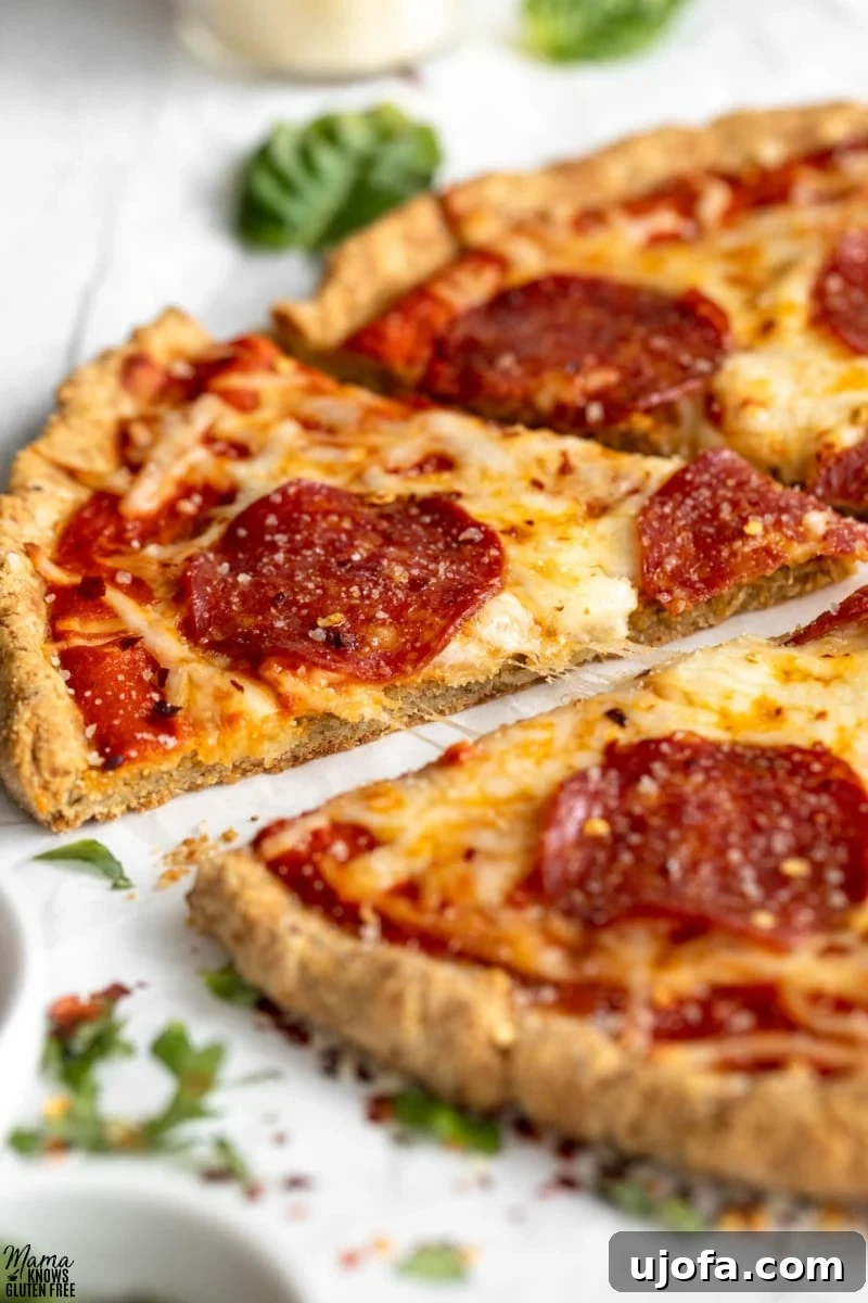 Crispy Gluten-Free Almond Flour Pizza Crust 4 A close-up shot of a perfectly baked slice of pepperoni pizza, showcasing a crispy, golden-brown Gluten-Free Almond Flour Pizza Crust, ready to be enjoyed.