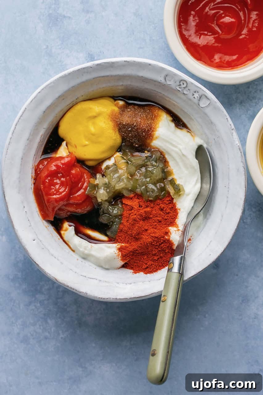 All Big Mac sauce ingredients in a bowl with a spoon before mixing