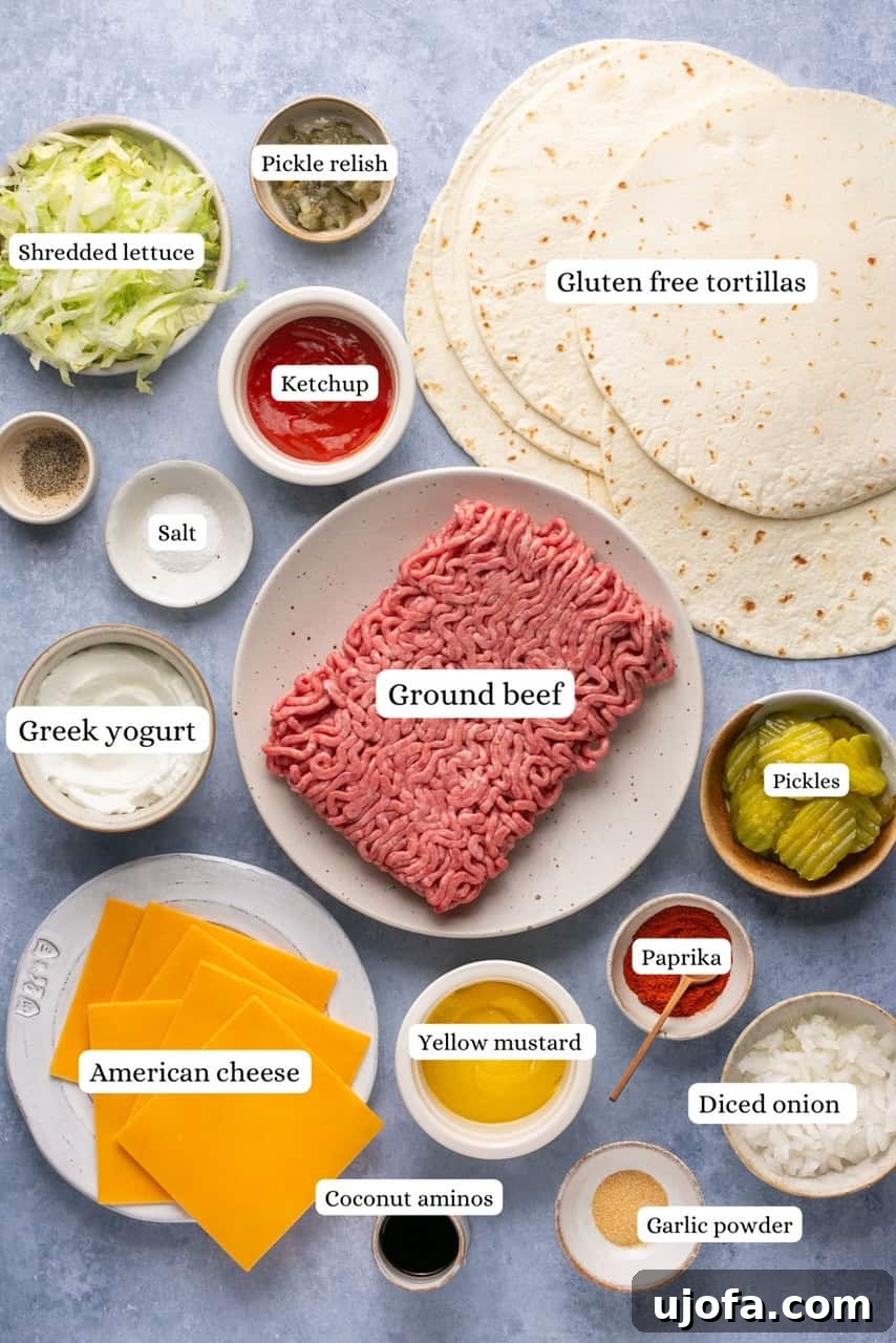 Arrangement of Big Mac taco ingredients in individual bowls: ground beef, gluten-free tortillas, American cheese slices, shredded lettuce, chopped white onion, pickles, and Big Mac sauce components.