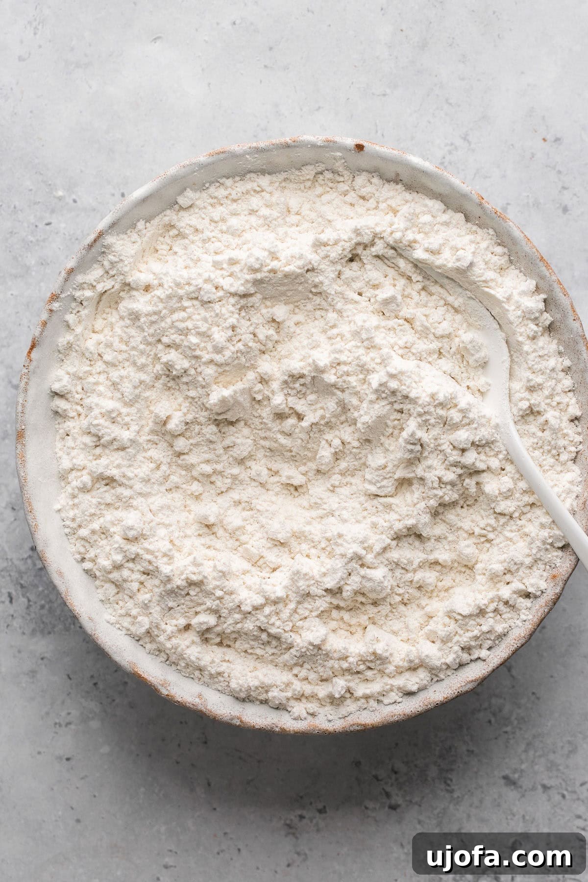 Dry ingredients, including gluten-free flour, baking soda, and salt, in a mixing bowl.