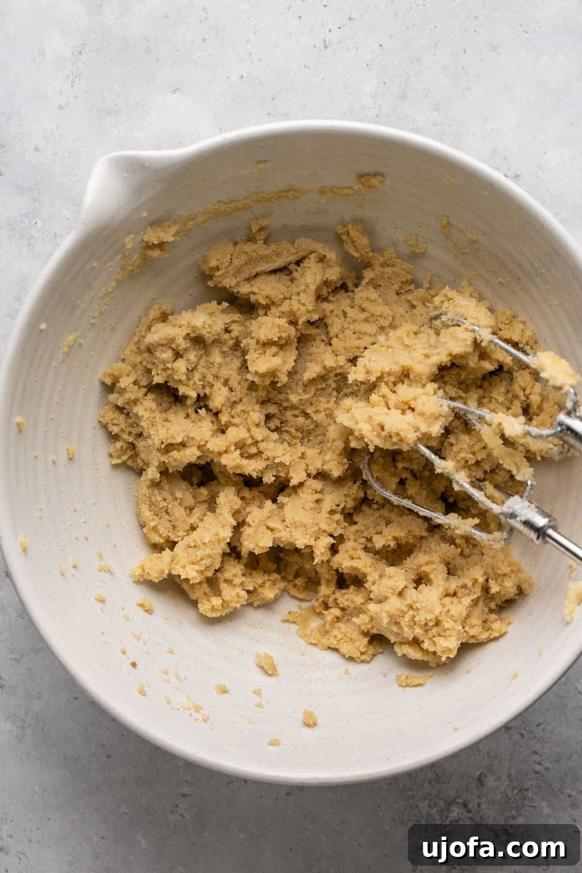 Creamed butter, brown sugar, and granulated sugar in a bowl, light and fluffy.