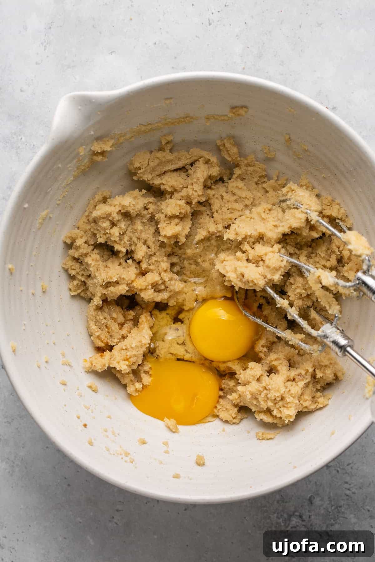 Creamed butter and sugar mixture with one whole egg, one egg yolk, and vanilla extract added.