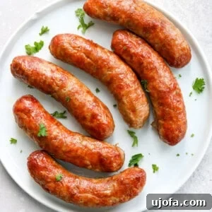 air fried Italian sausage on a white plate topped with parsley