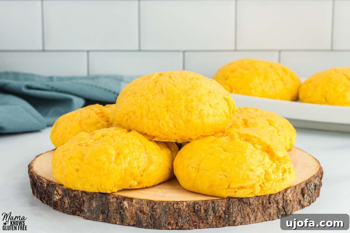 Five Gluten-Free Sweet Potato Rolls placed on wooden serving platter.