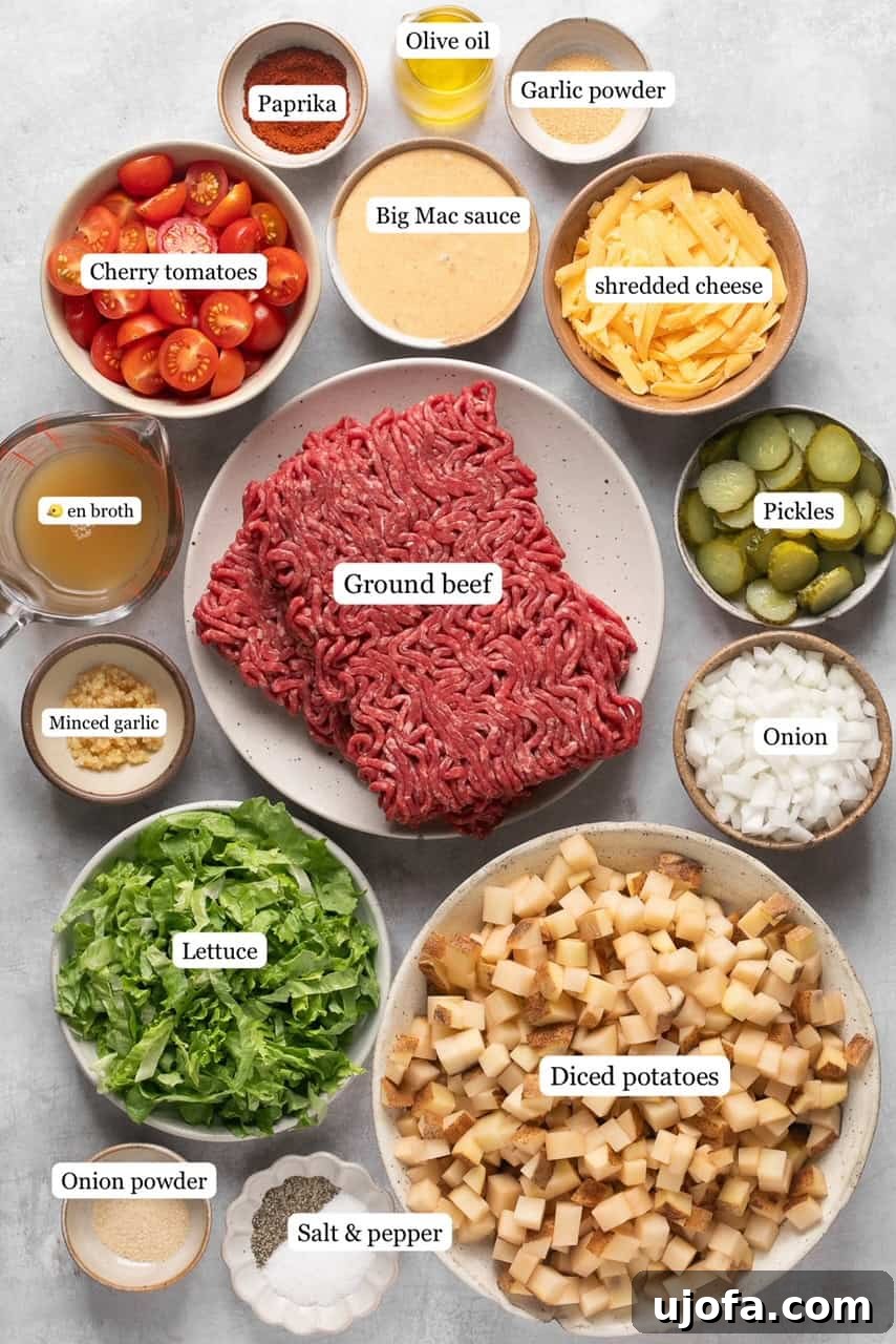 A flat lay photograph showcasing all the fresh ingredients needed for Big Mac Casserole, including diced potatoes, ground beef, cheese, lettuce, and various seasonings.
