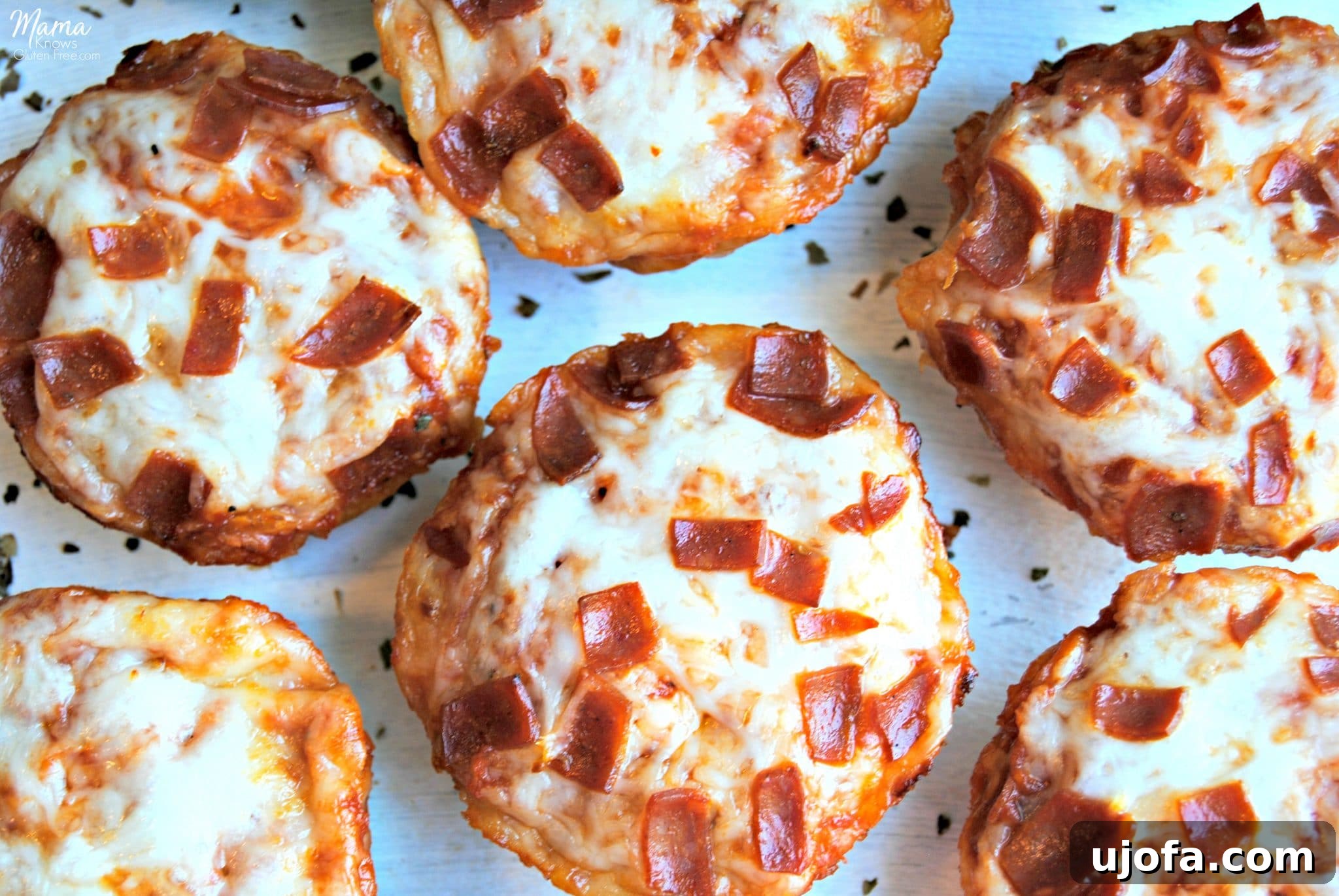 Gluten-Free Pizza Bites Dairy-Free Friendly 4 An inviting overhead shot of several golden-brown gluten-free deep dish pizza bites, freshly baked and ready to be enjoyed, showcasing their perfect size and delicious toppings.