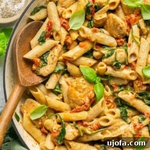 One Pan Proposal Chicken Pasta 8 Marry me chicken pasta in a skillet with a wooden spoon