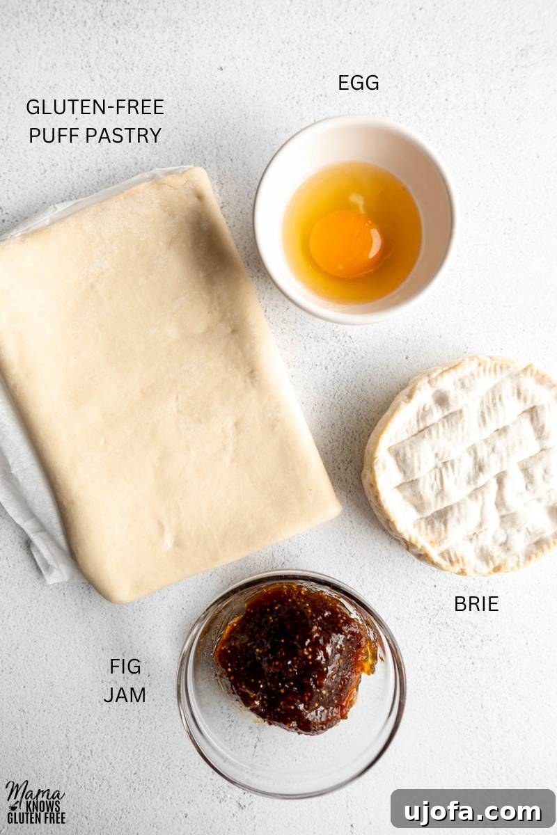 Ingredients to make Gluten-Free Baked Brie on white surface.