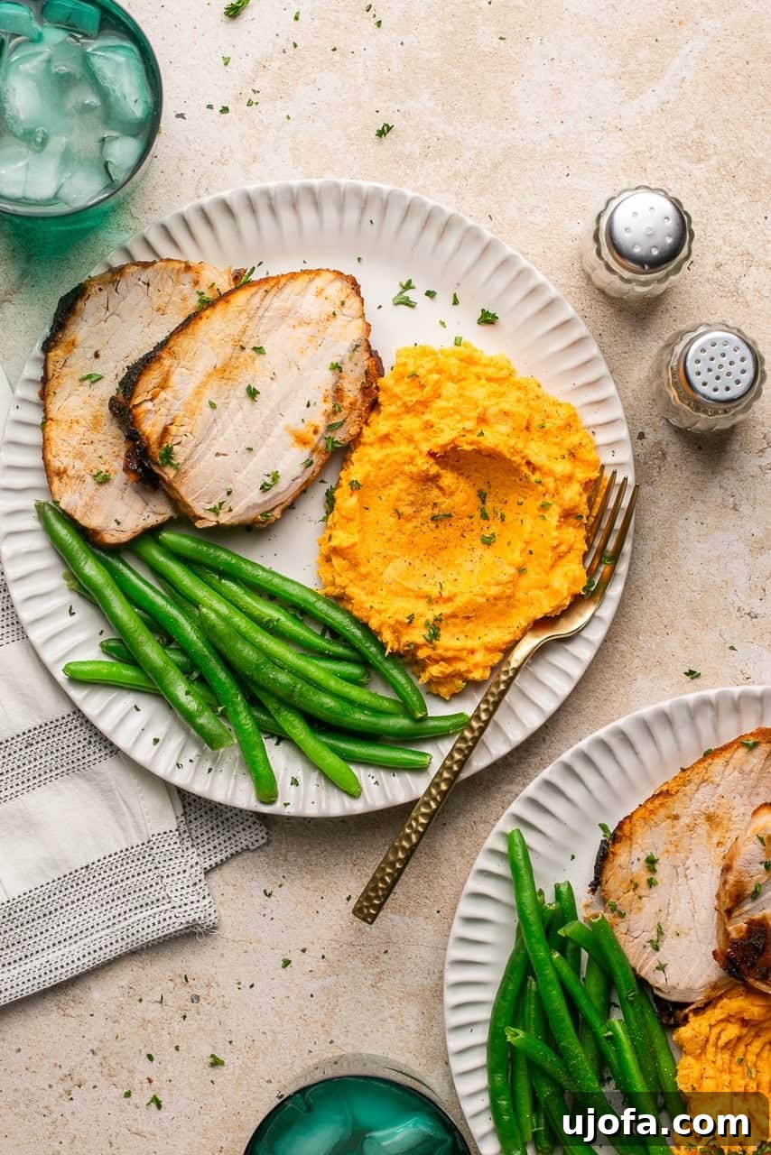 Golden Crust Air Fryer Pork Roast 8 2 plates with sliced pork roast, mashed sweet potatoes and green beans