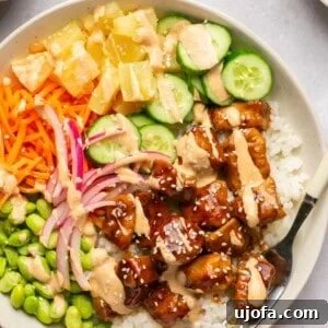 Sweet & Spicy Teriyaki Chicken Poke Bowls 9 chicken poke bowls with toppings and spicy mayo in a bowl
