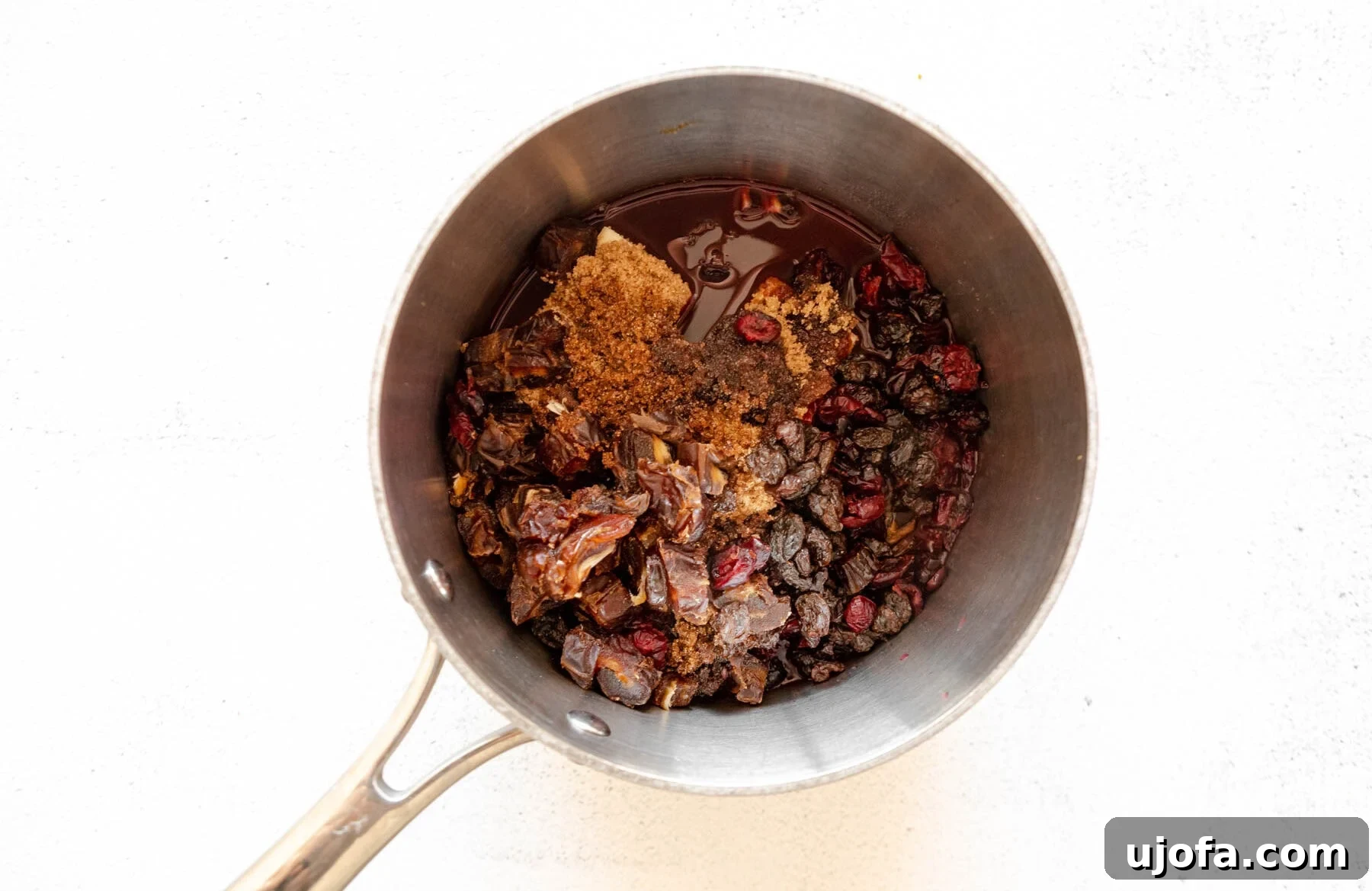 Sumptuous Gluten-Free Fruitcake 6 Dried fruit, butter, sugar, orange zest, and brandy in a saucepan, beginning to simmer.